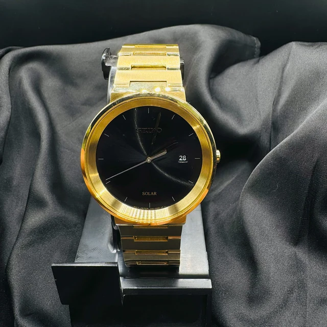 Reloj de esfera negra y dorada